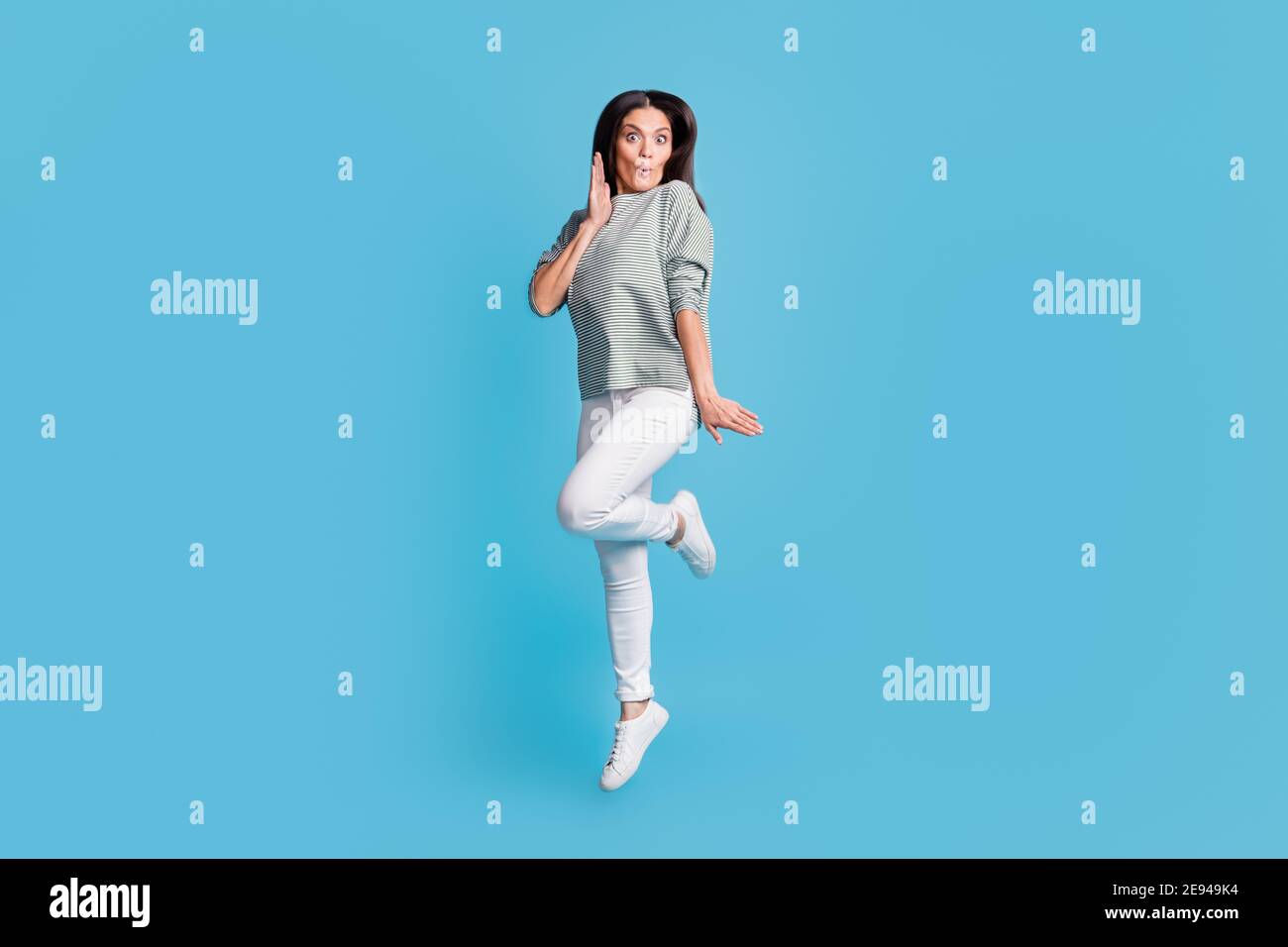 Full size portrait of attractive lady jumping arm near face lips wow