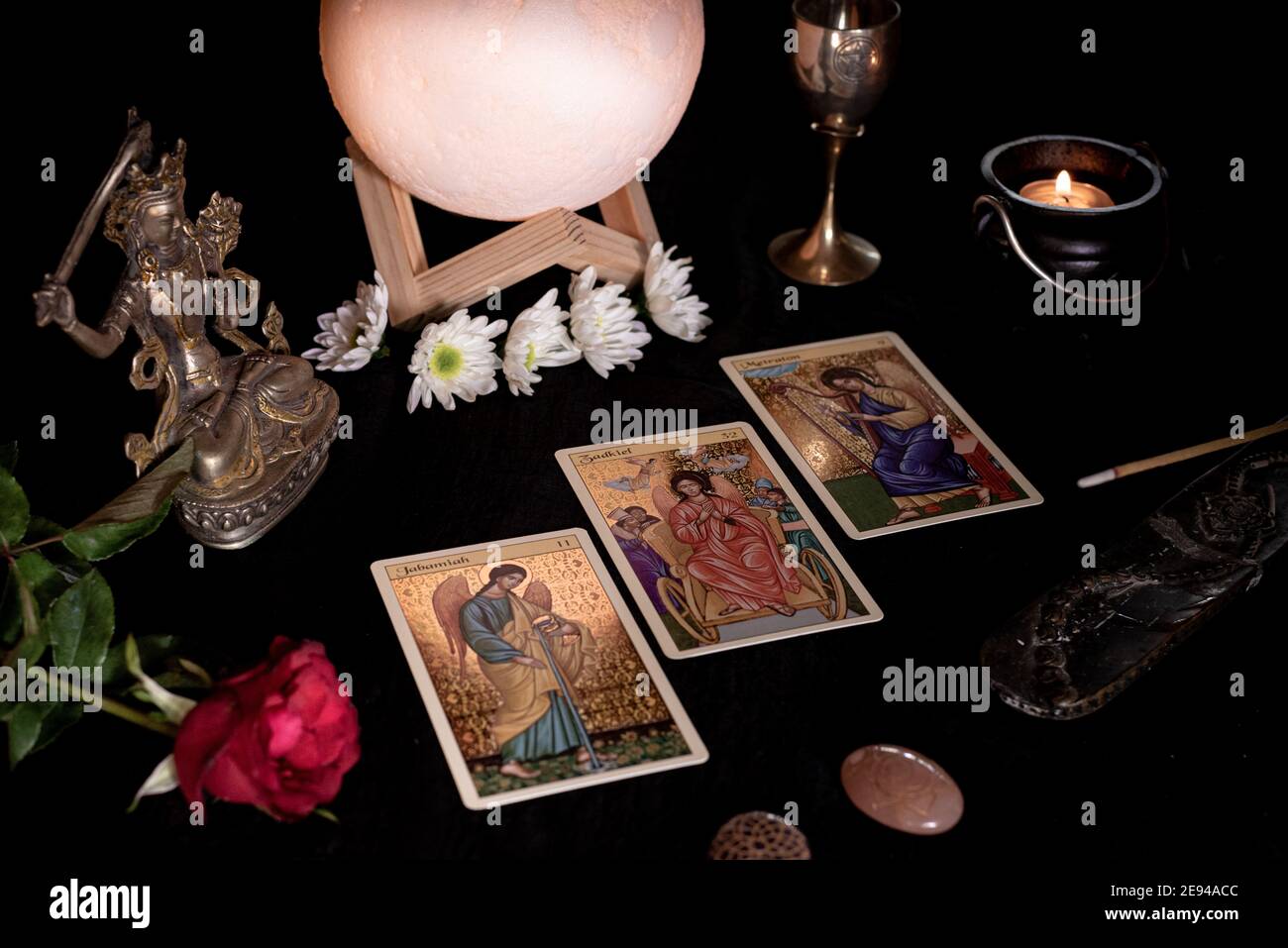 Tarot cards session 2, spreads, candles, crystals, minerals, statuettes and flowers Stock Photo