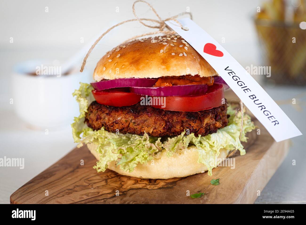 Homemade vegetarian hamburger on an olive wood board, close-up, a sign I LOVE VEGGIE BURGER Stock Photo