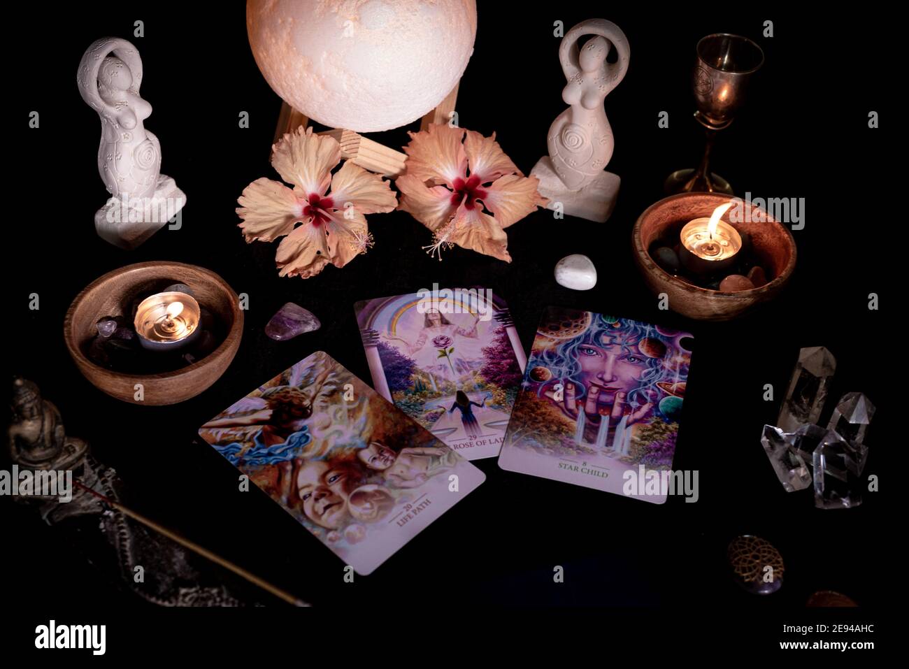 Tarot cards session 2, spreads, candles, crystals, minerals, statuettes and flowers Stock Photo