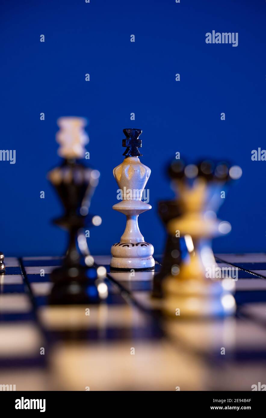Premium Photo  Chess pieces and game board on dark blue background