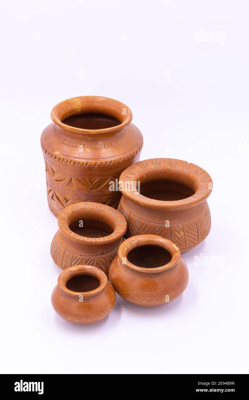 Earthen pots with design and patterns kept together with white background Stock Photo Alamy