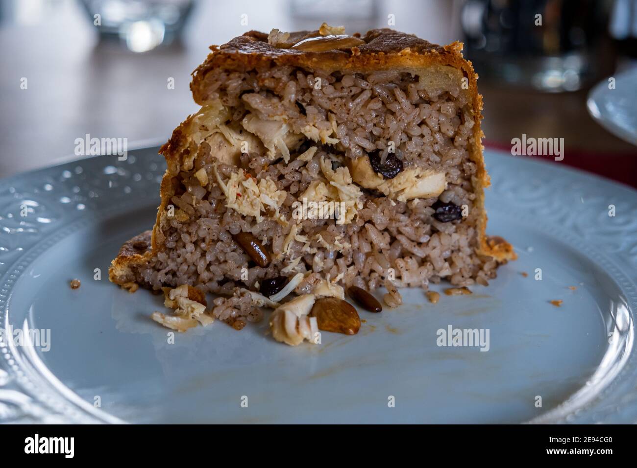 Pilaf with chicken and nuts enveloped in thin dough topped with almonds Stock Photo