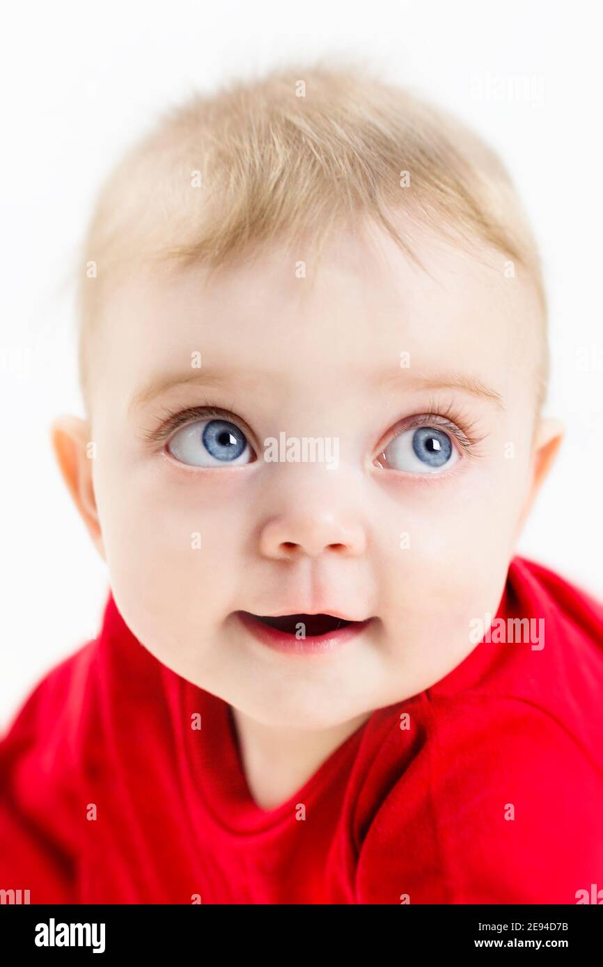 The face of a beautiful child with blue eyes and long eyelashes, close