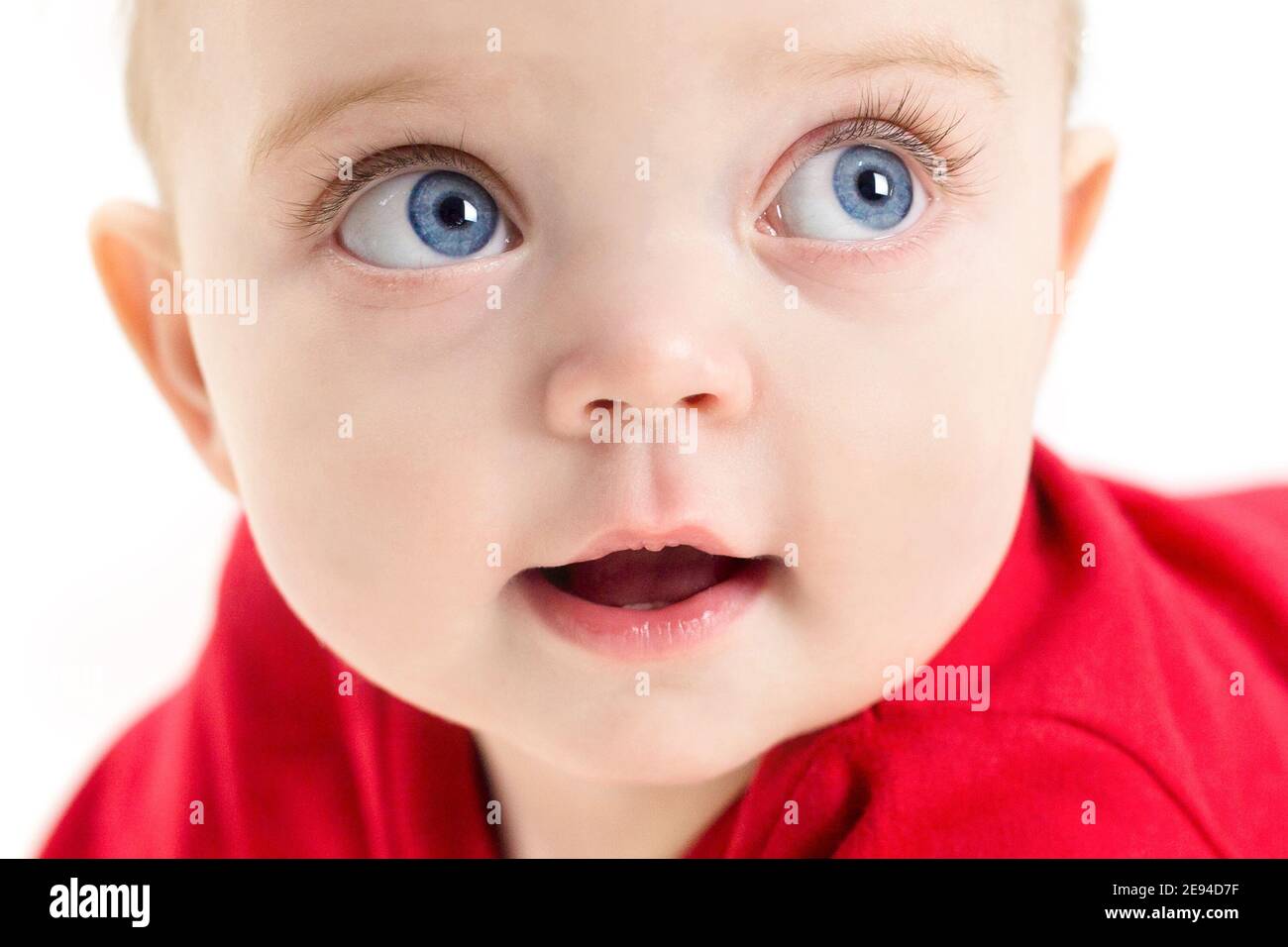 The face of a beautiful child with blue eyes and long eyelashes, close