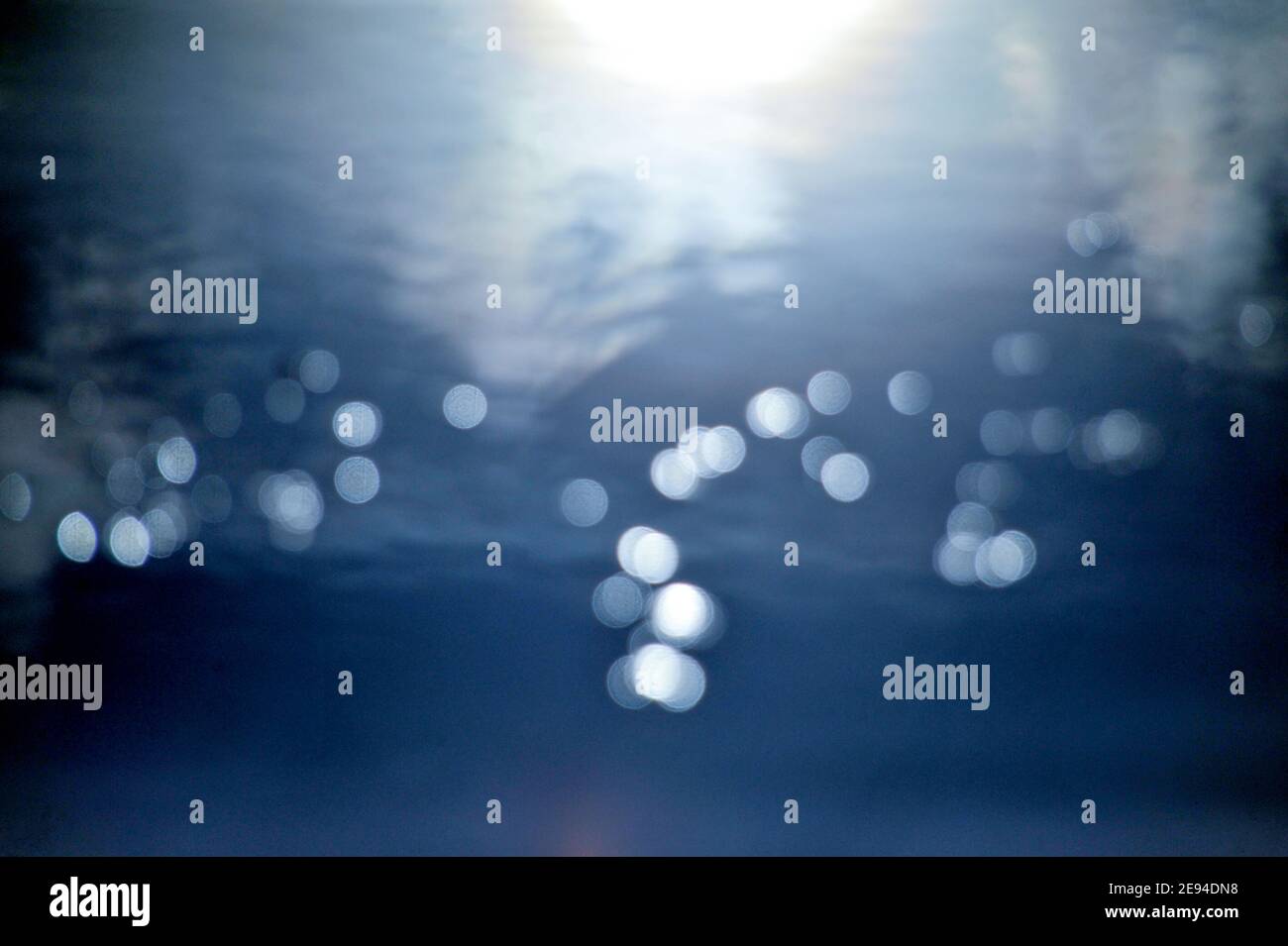 Blue elegant abstract background with bokeh lights image,reflection of sun on a water Stock Photo