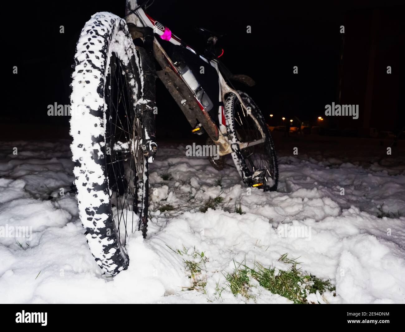 Mtb riding in snow.  Extreme fun. Front wheel with large grips on fat tyre. Winter adventure and extreme biking. Stock Photo