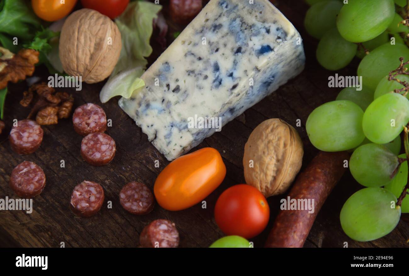 blue cheese with fruit and pepperoni sausage Stock Photo Alamy