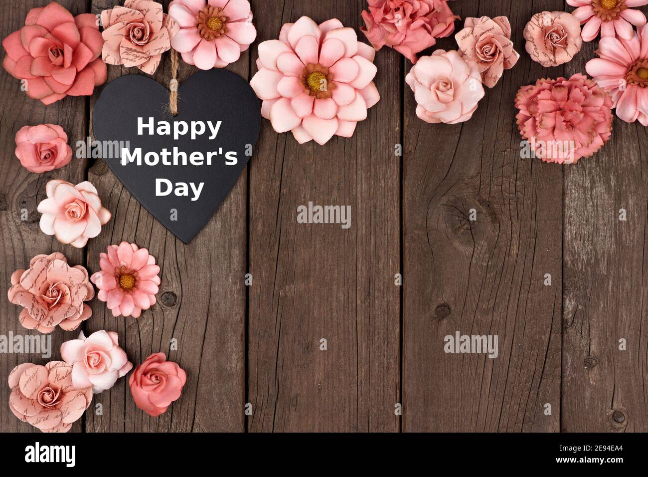 Happy Mothers Day chalkboard heart with rustic paper flower corner border  over a wood background Stock Photo - Alamy