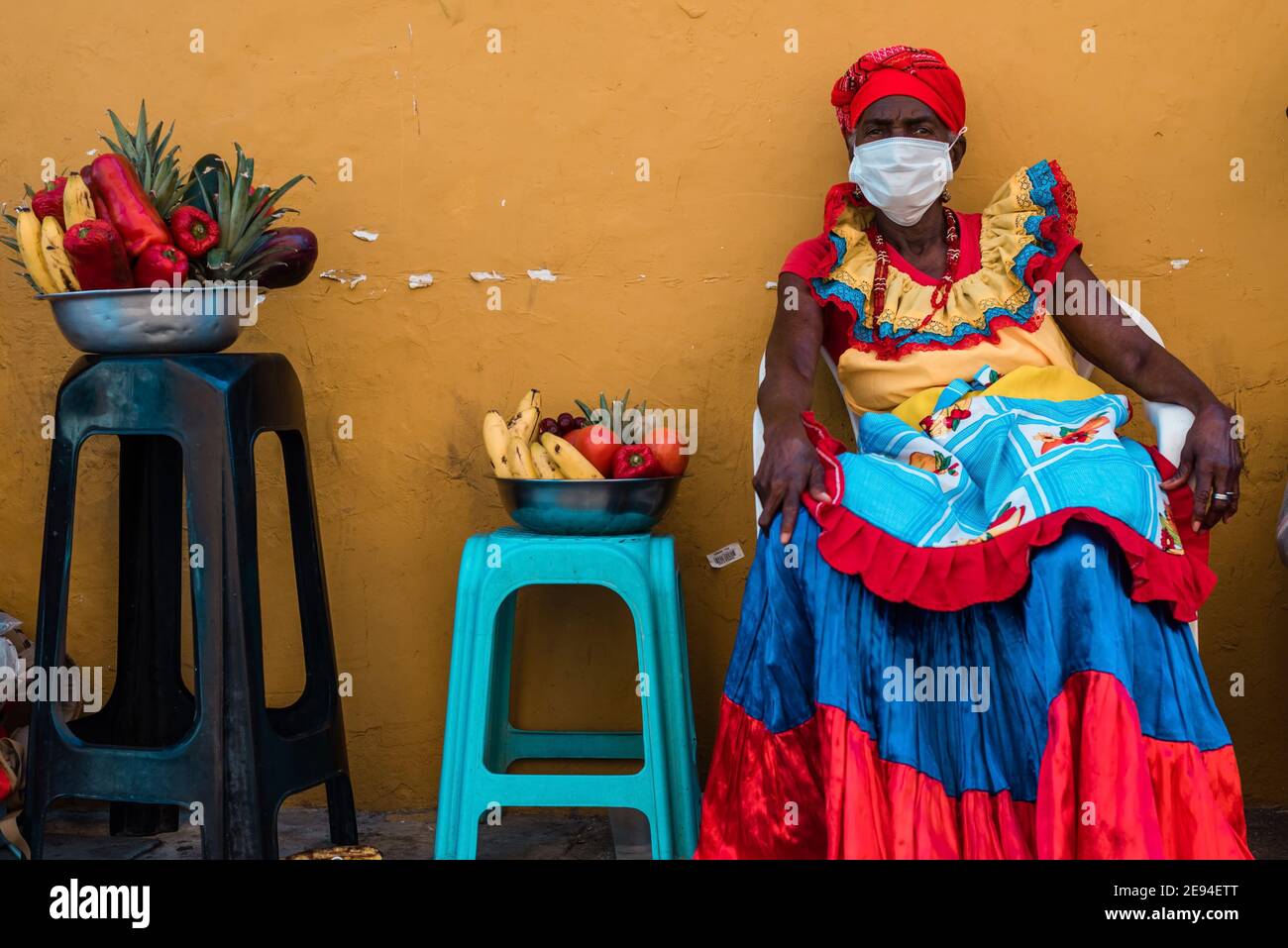 Cartagena, Colombia, February 2021: Women fruit vendors fruits sellers named Palenquera wearing face mask during the Pandemic COVID 19. Visit Columbia Stock Photo