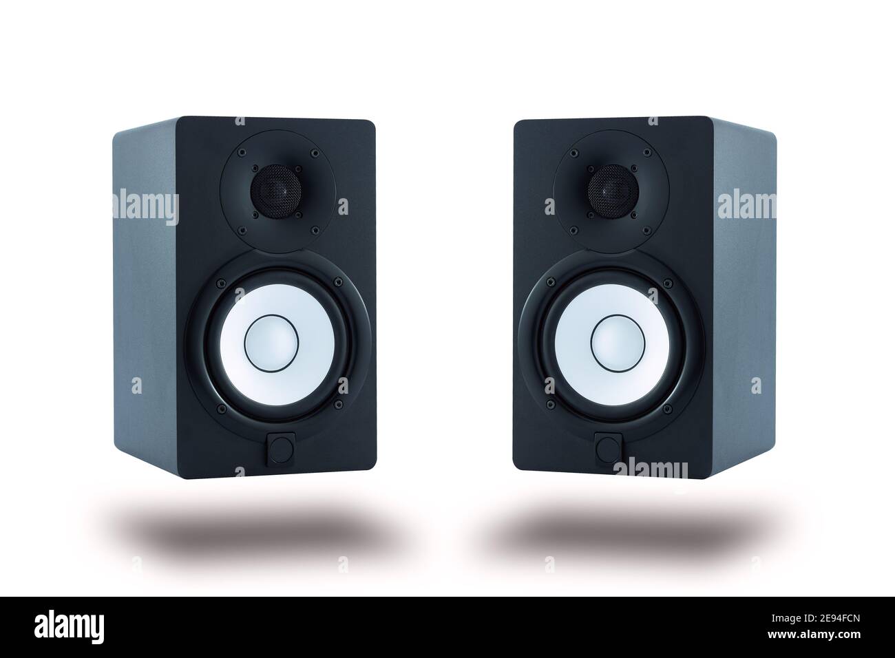 Pair of professional high quality monitor speakers for sound recording, mixing, and mastering in studio in black wooden casing isolated. Stock Photo