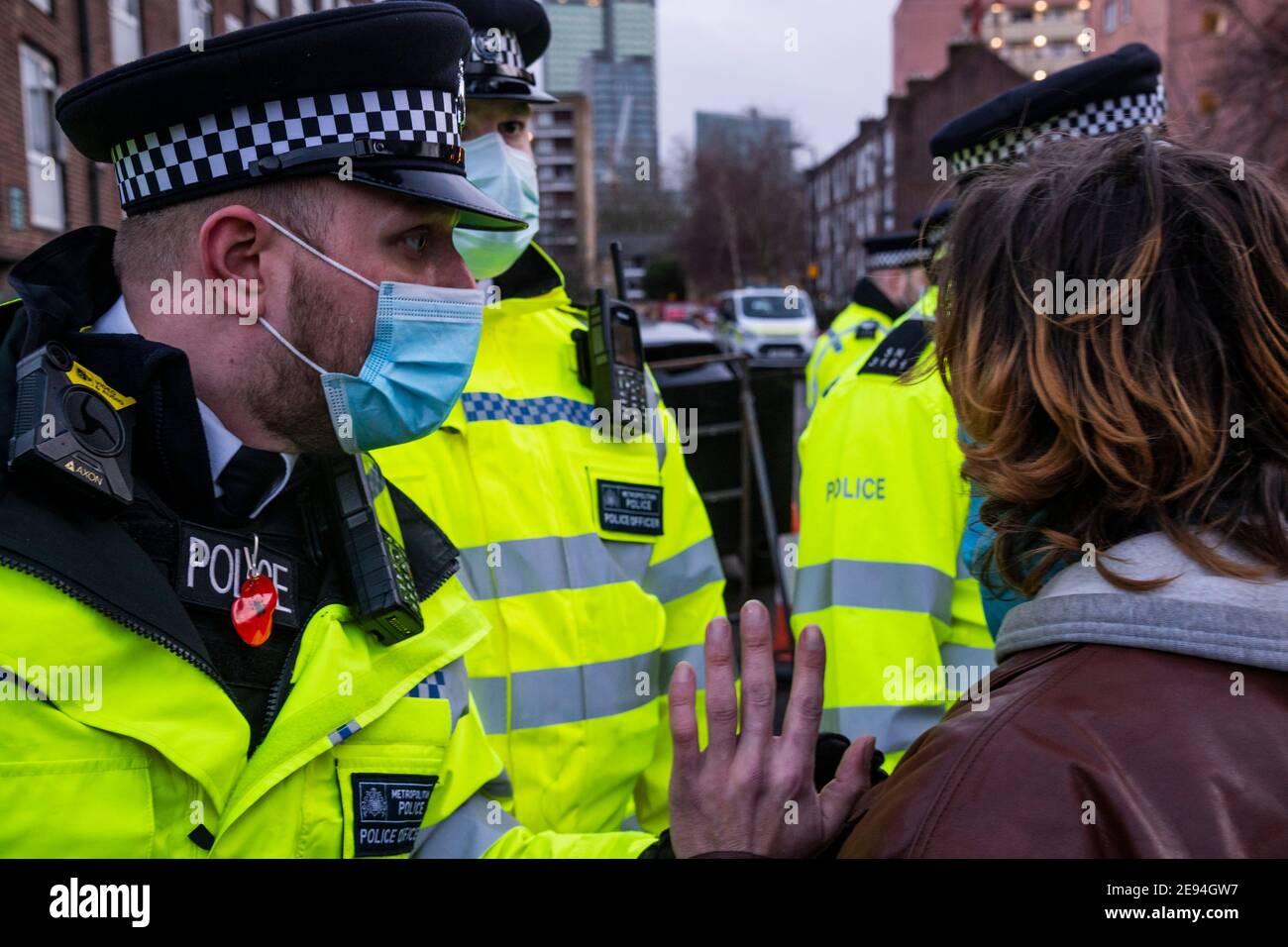 London, UK. 2 Feb 2021. Eventually HS2 security start to bring protesters out and they are arrested by the police which leads to some scuffling - Supporters from Extinction Rebellion stage a protest at a construction site near Camden which brings work to an end on HS2, at least temporarily - they have a banner which says Essential Work Should Heal Not Harm. The anti HS2 Extinction Rebellion camp continues to be cleared (in order to create a temporary parking area) by Bailiffs (from the National Enforcement Team, NET, a subsidiary of High Court Enforcement Group) at Euston Station. Credit: Guy Stock Photo