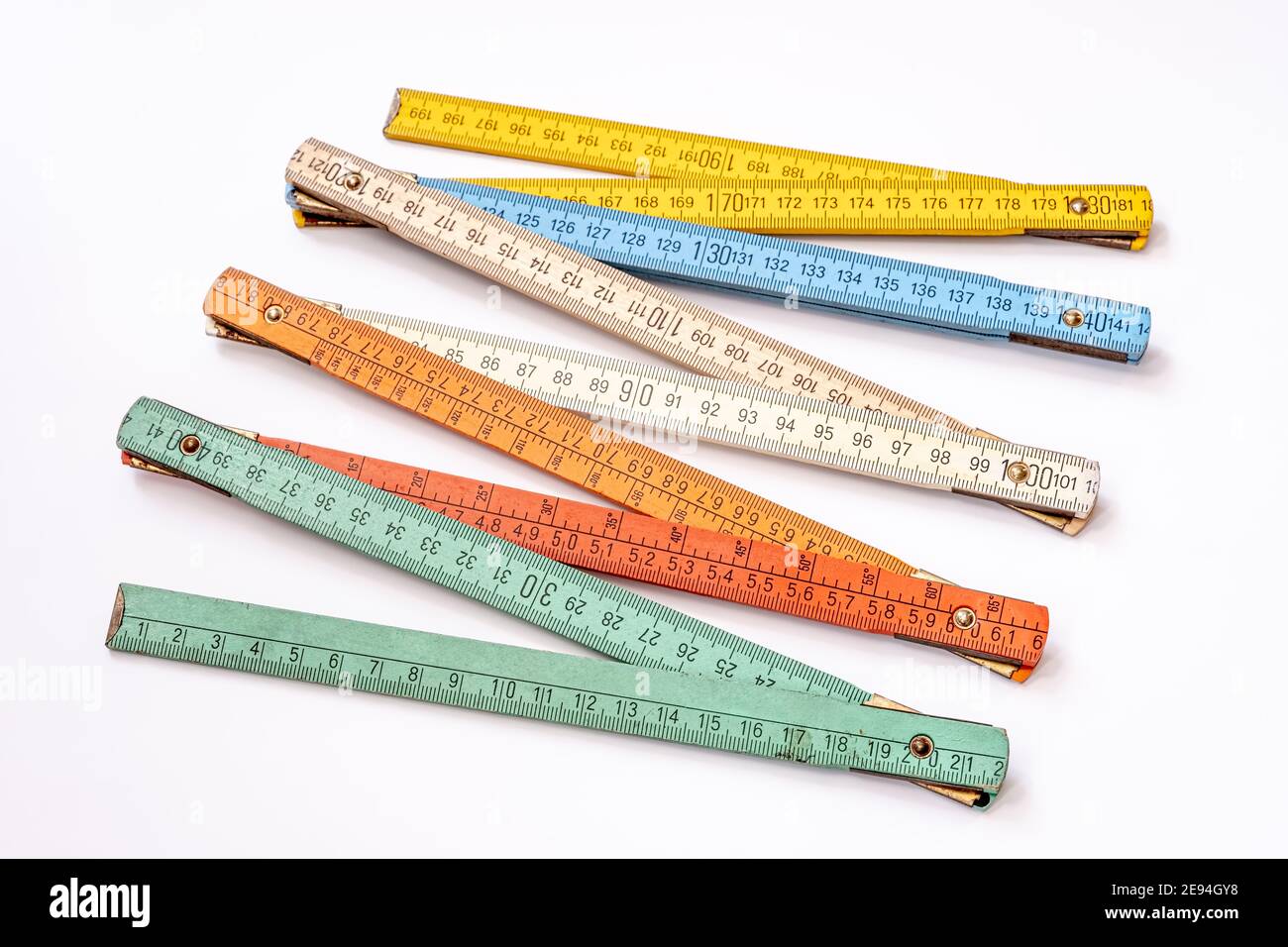 Multi Colored Ruler Vintage multicolored wooden folding ruler isolated on a white ...