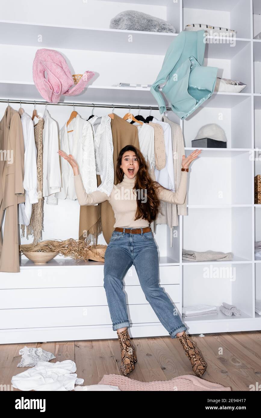 Woman throwing clothes in closet hires stock photography and images Alamy