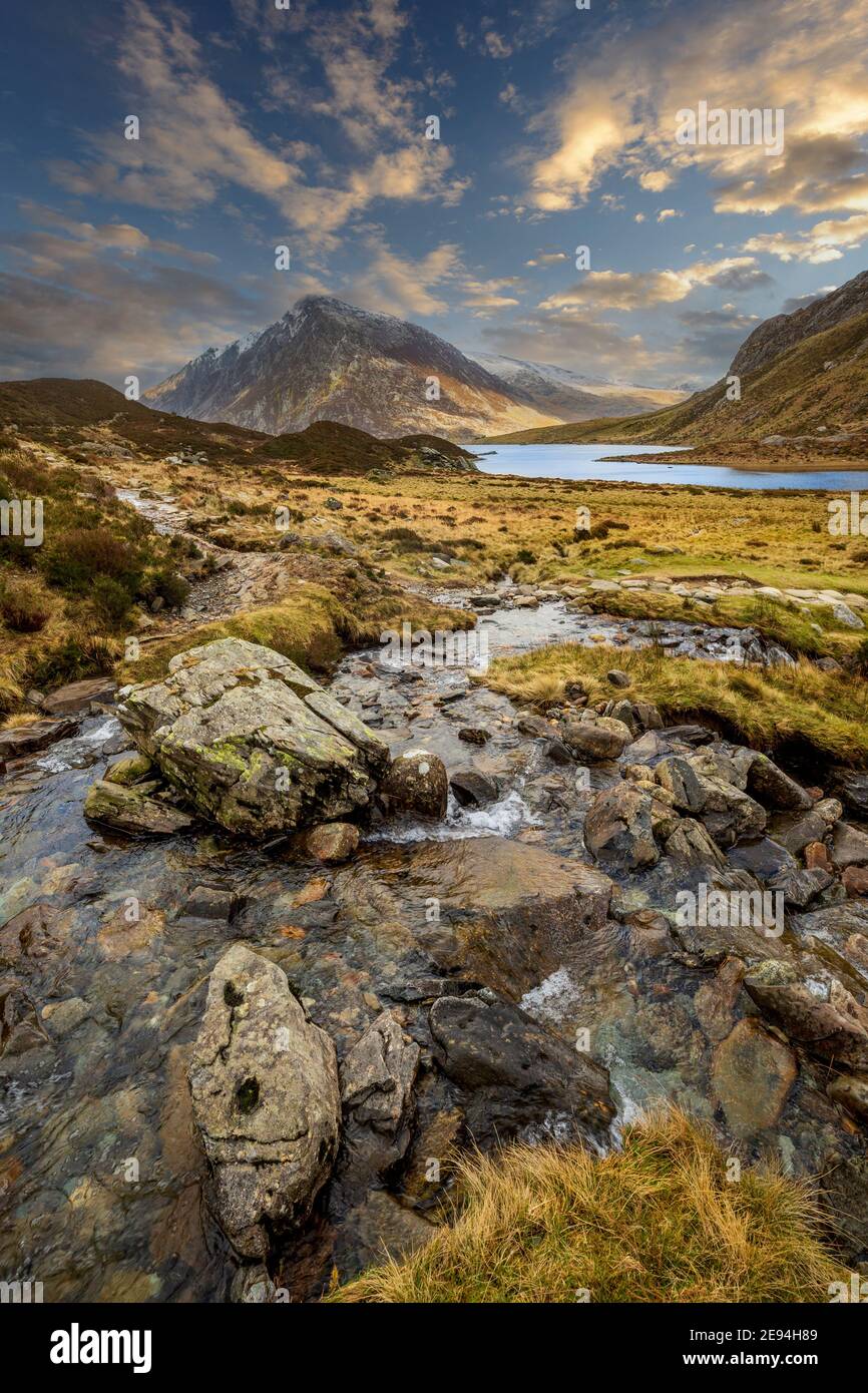 A stream leading to Lake Idwal in Cwm Idwal Nature Reserve with Pen yr Ole Wen mountain in the background, Snowdonia, Wales Stock Photo