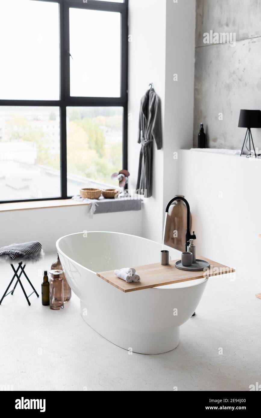Interior of modern bathroom with white bathtub Stock Photo - Alamy