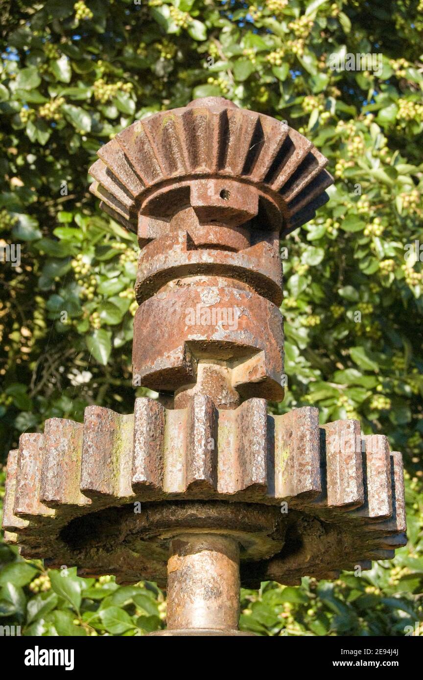 Iron cogs and bevels rusting in a garden. Formerly part of a riverside lock mechanism. Stock Photo