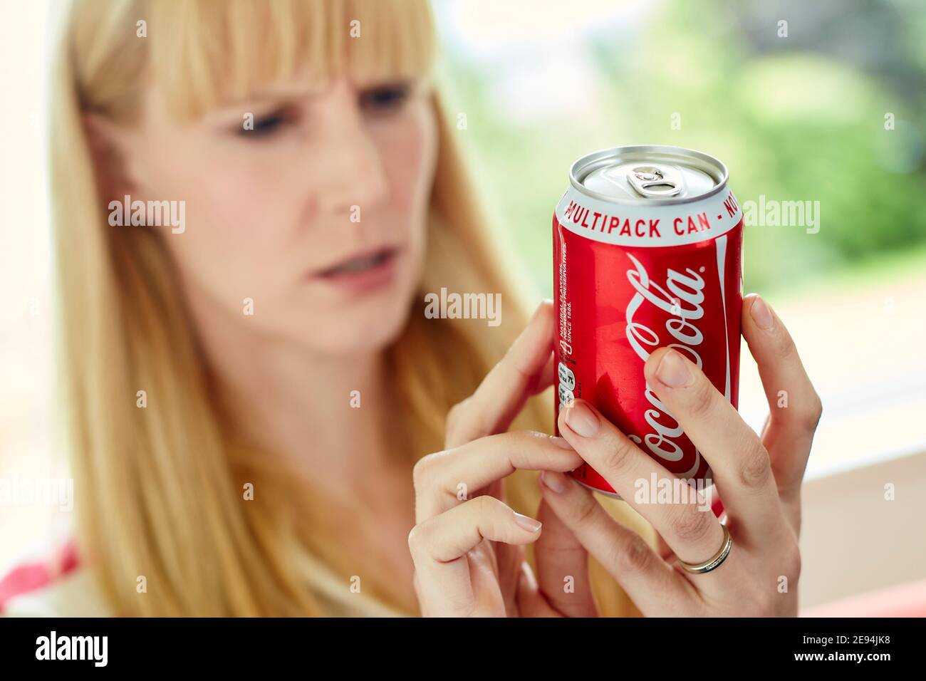 Woman drinking Coke from a tin Stock Photo
