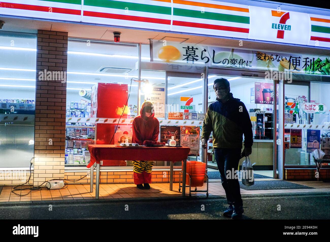 A 7Eleven employee dressed as a demon sells Ehomaki outside a 7