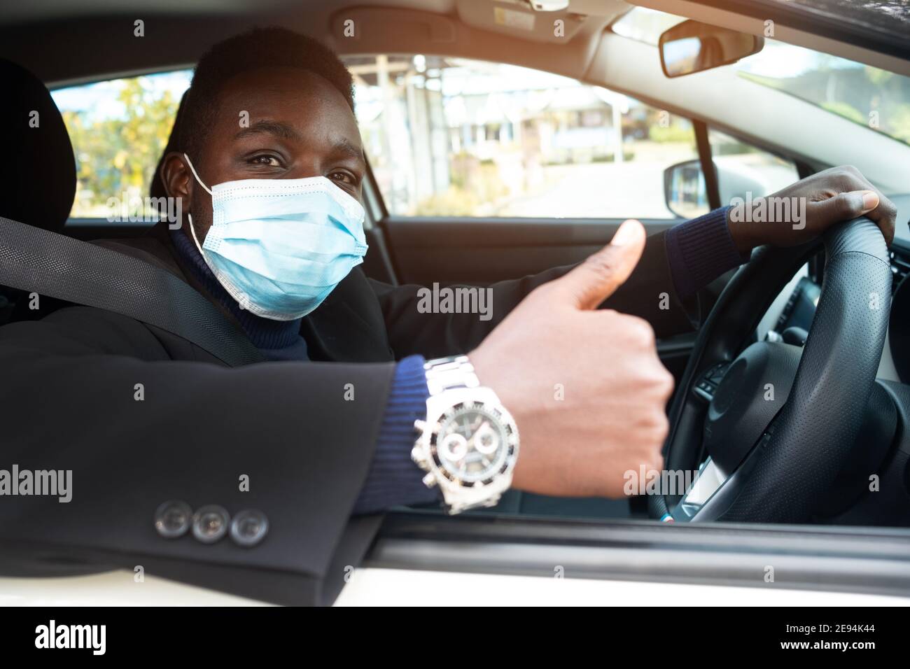 African business man driving car with wearing medical mask Stock Photo