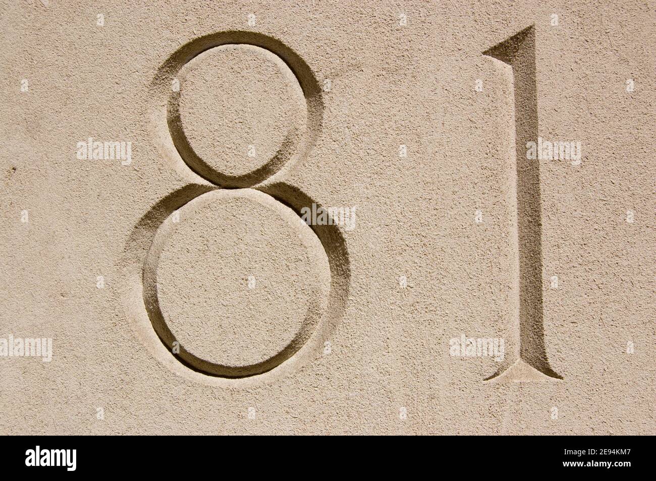 Number eighty one (81) carved into the outside wall of an office in London. Stock Photo