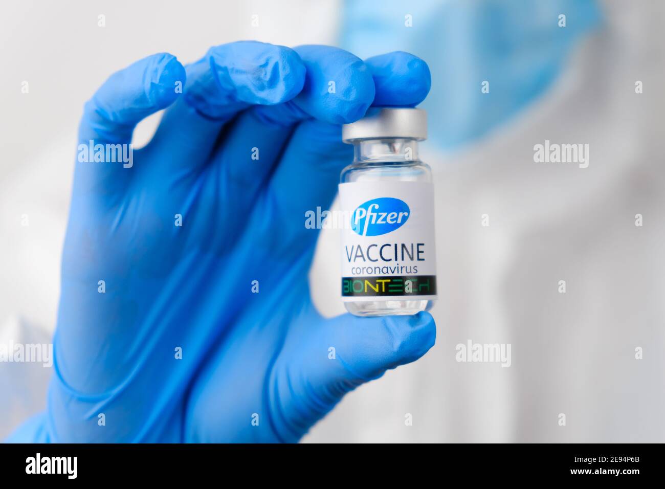 Pfizer coronavirus vaccine in doctors or nurses hands in blue rubber gloves. Prevention of sars-cov-2 or Covid-19, January 2021, San Francisco, USA. Stock Photo