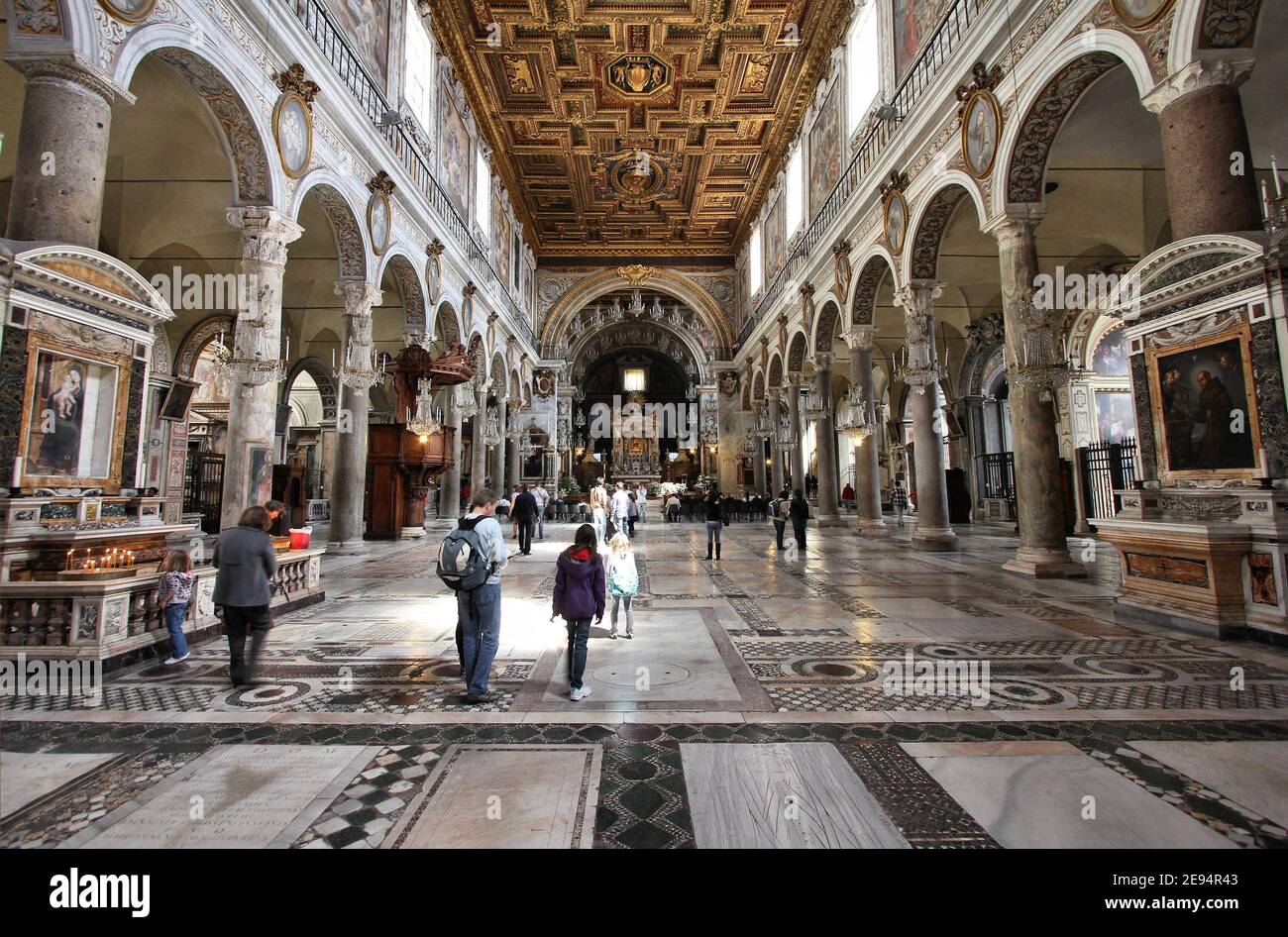ROME, ITALY - APRIL 8, 2012: Tourists visit Basilica Santa Maria in Aracoeli in Rome. The famous romanesque church dates back to 12th century. Stock Photo