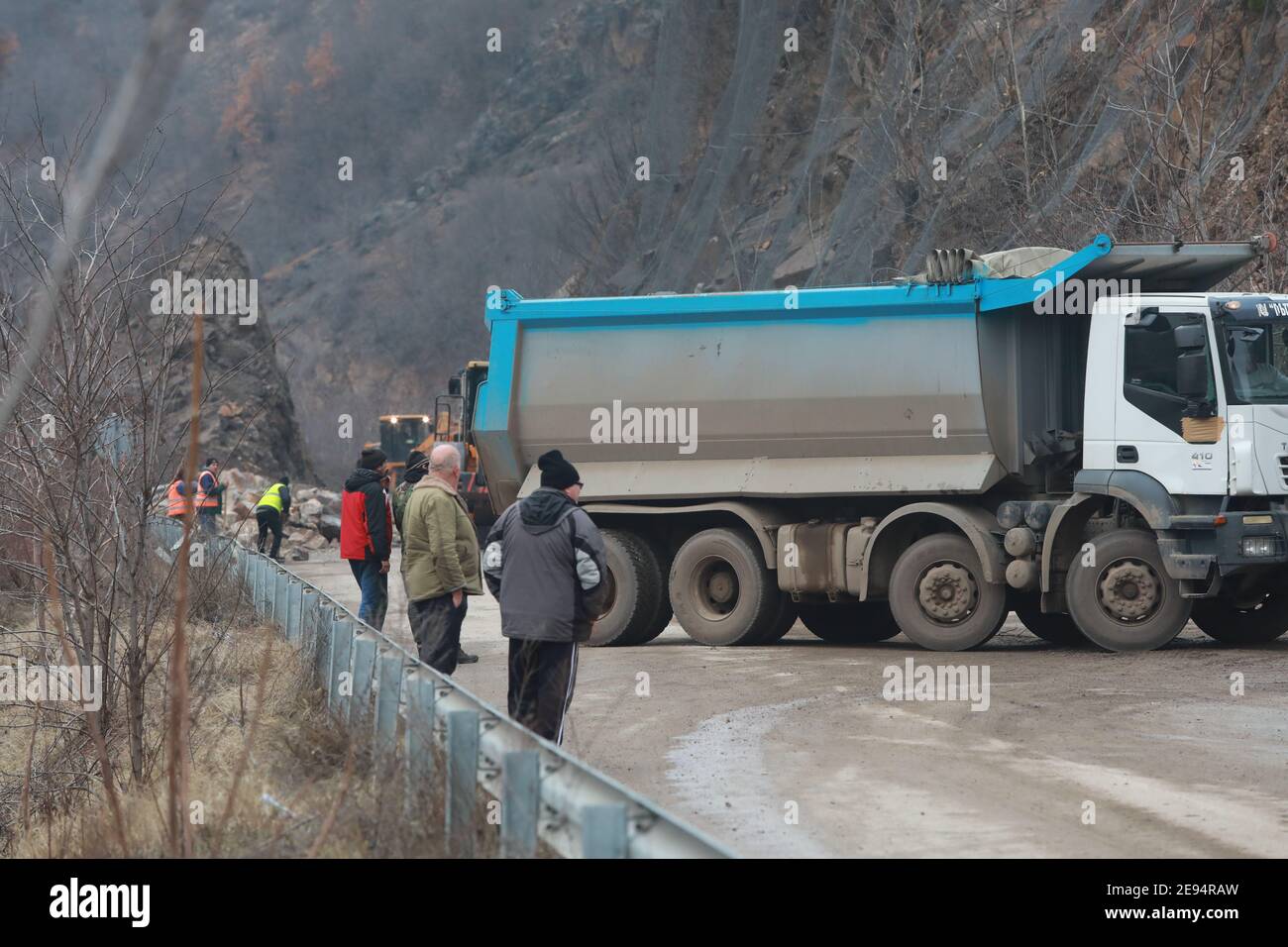 Heavy chain and wheeled equipment clears the highway after a rock collapse near Elisseina station, Bulgaria Stock Photo