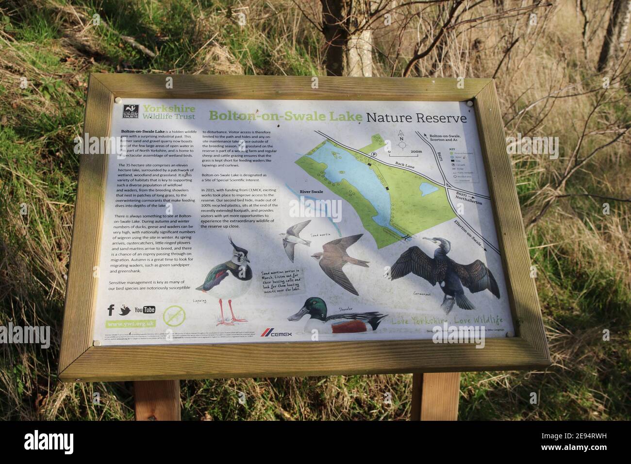 Notice board showing information and map of Yorkshire Wildlife Trust nature reserve Bolton on Swale Lakes, Bolton on Swale, N.Yorks, England, UK. Stock Photo