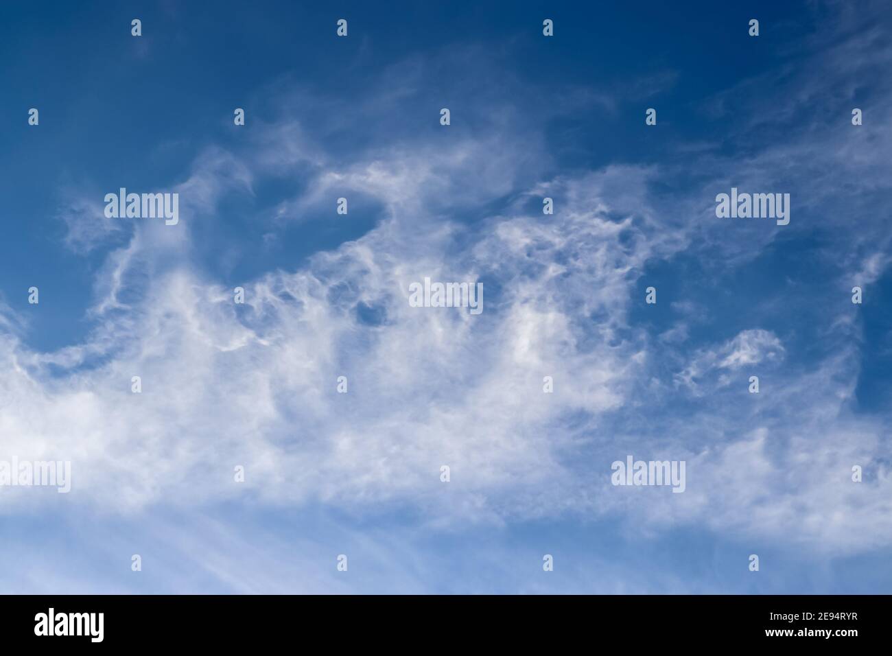 Stunning cirrus cloud formation panorama in a deep blue summer sky seen ...