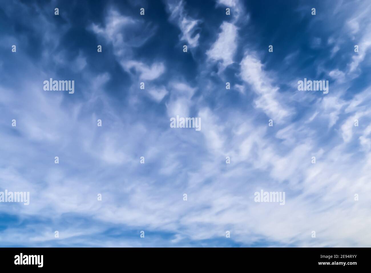 Stunning cirrus cloud formation panorama in a deep blue summer sky seen ...