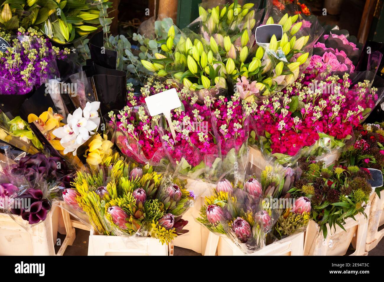 Various flower bouquets in baskets with price tags for sale at a street market in England Stock Photo