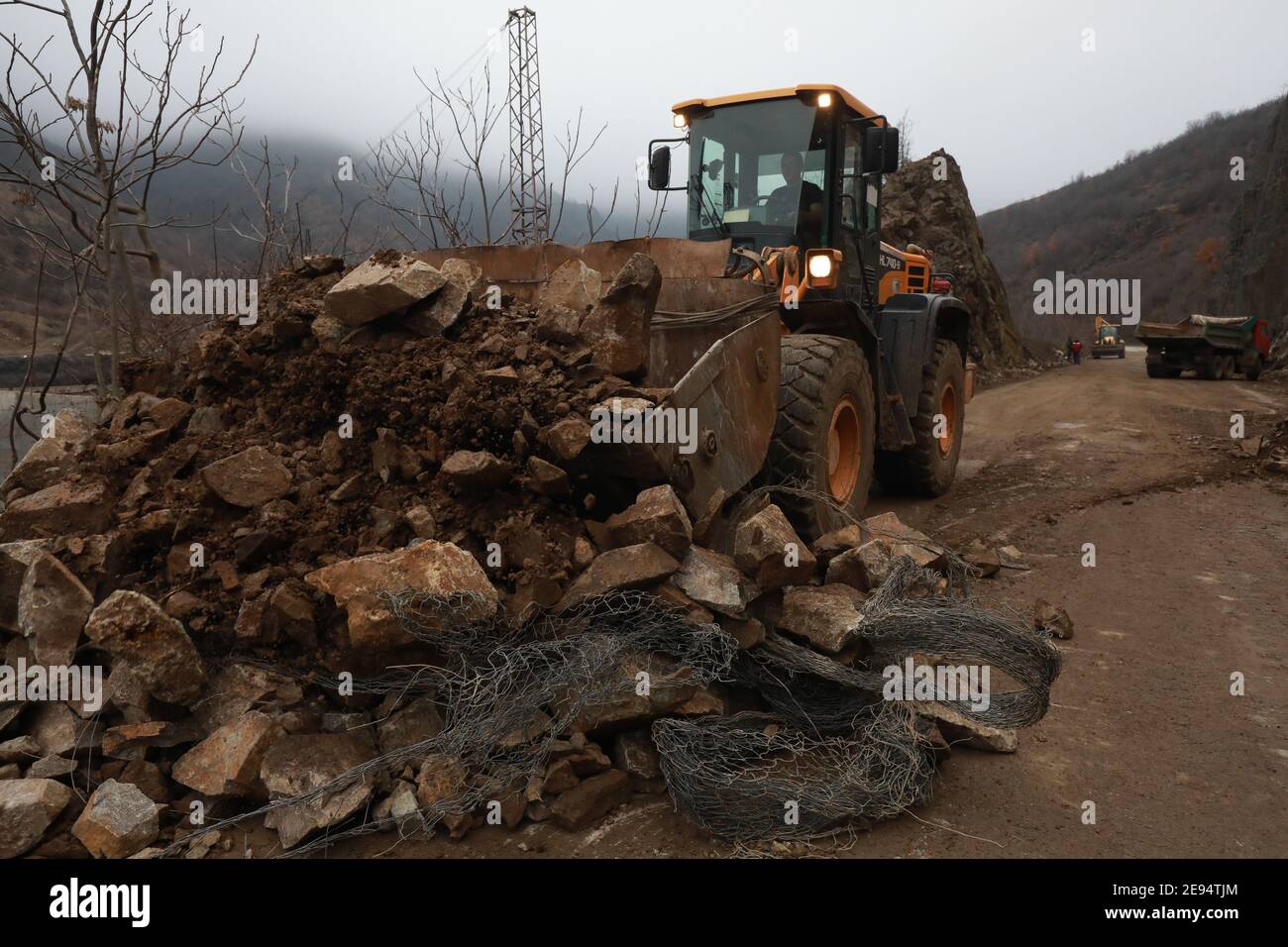 Heavy chain and wheeled equipment clears the highway after a rock collapse near Elisseina station, Bulgaria Stock Photo