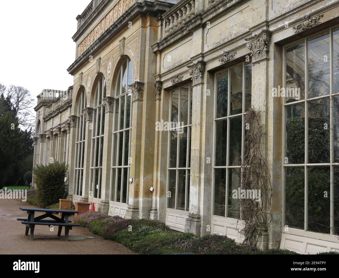 Built from limestone in 1872, an exterior view of the Orangerie or Palm House in the grounds of the Castle Ashby estate in Northamptonshire. Stock Photo