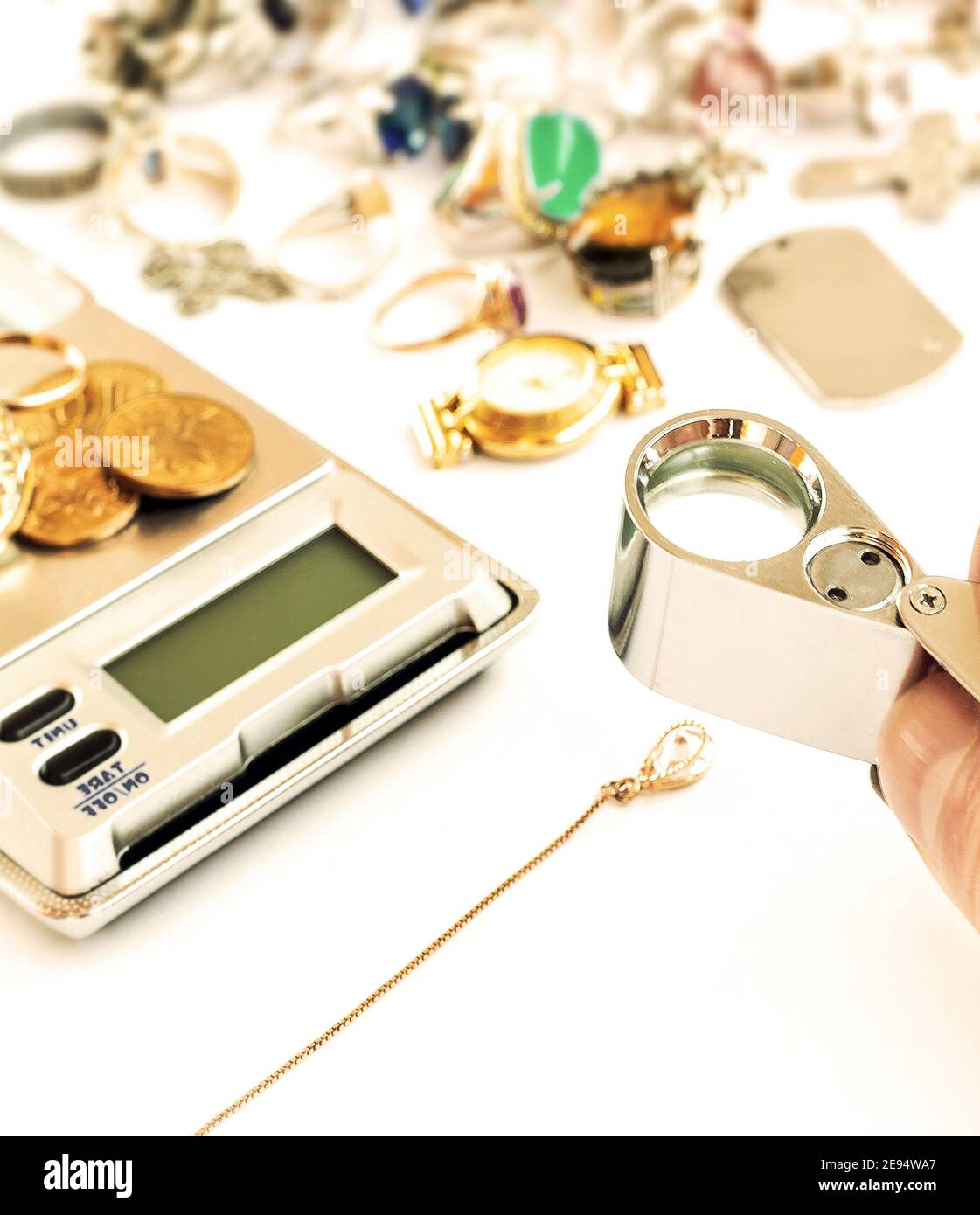 pawn broker checking the diamond Stock Photo Alamy