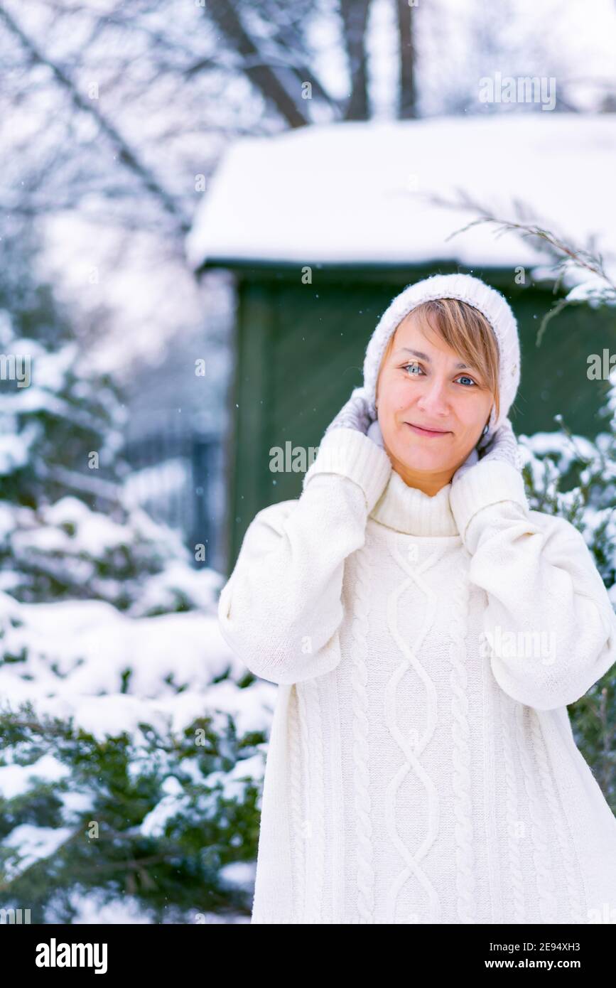 Outdoor winter portrait of happy smiling woman posing in park in front ...