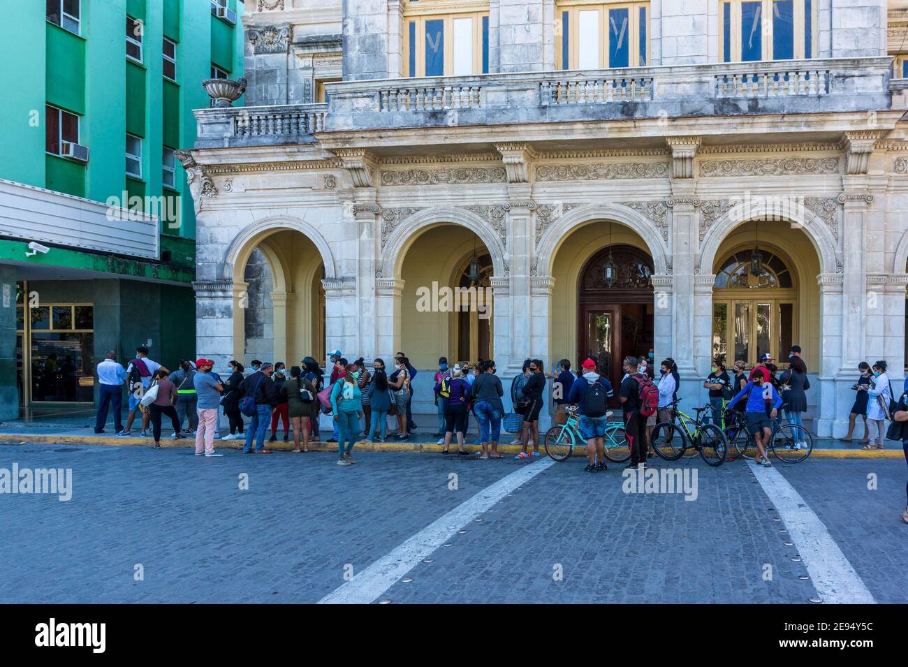 Cuban people lining-up to buy two bottles per person of 1.5 liters of cola carbonated drink in Santa Clara, Cuba. Stock Photo