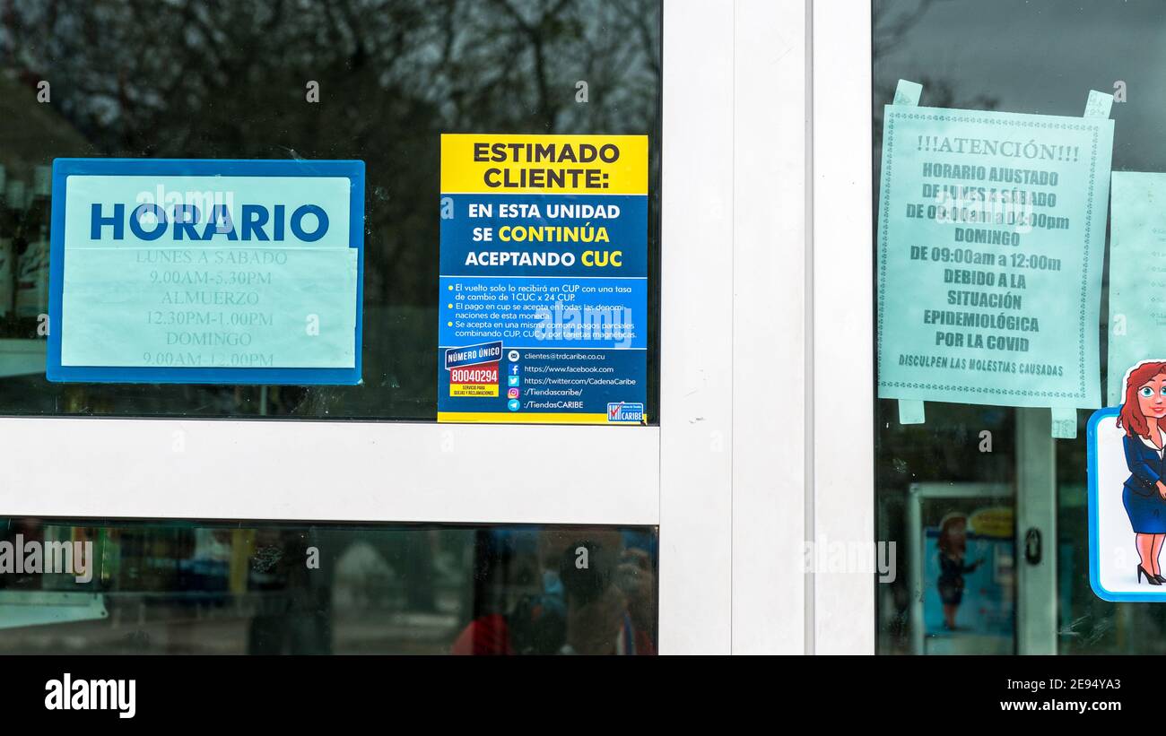 Sign announcing that a store still accepts CUC (Cuban Convertible Pesos)  after the new economic measures that announced its disappearance from the Cu Stock Photo