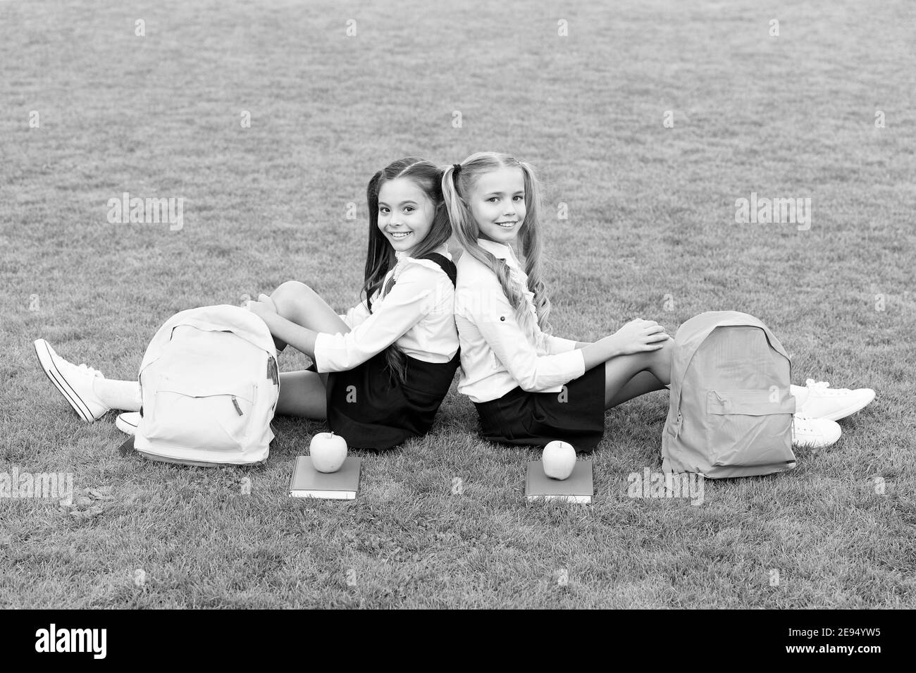 Friends makes you happy. School friends relax on green grass. Happy