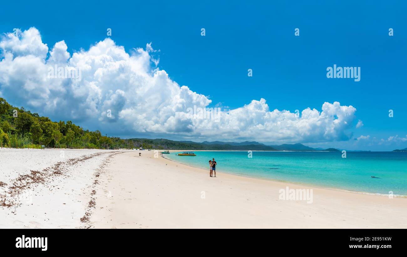 Whitehaven Beach, Queensland, Australia - February 2, 2021: People on Whitehaven Beach swimming, relaxing and enjoying the beautiful sunshine. Stock Photo