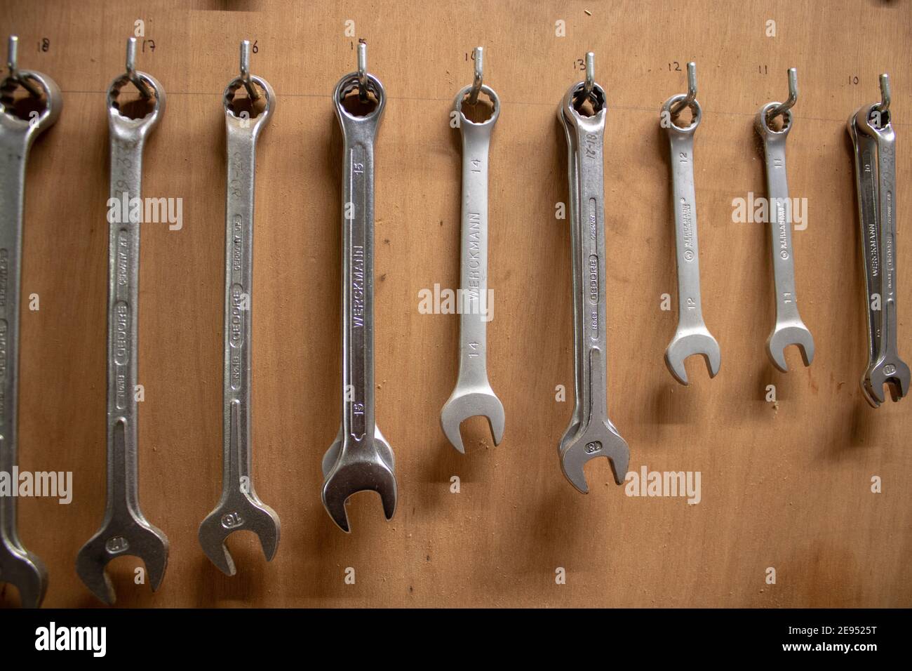Collection of wrenches in a workshop on a background of plywood Stock Photo