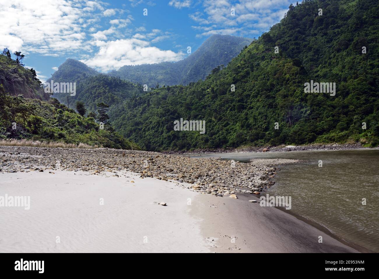 The Trishuli River is a major tributary of the Narayani River in central Nepal but originates in Tibet. Here it is adjacent to the Prithvi Highway. Stock Photo