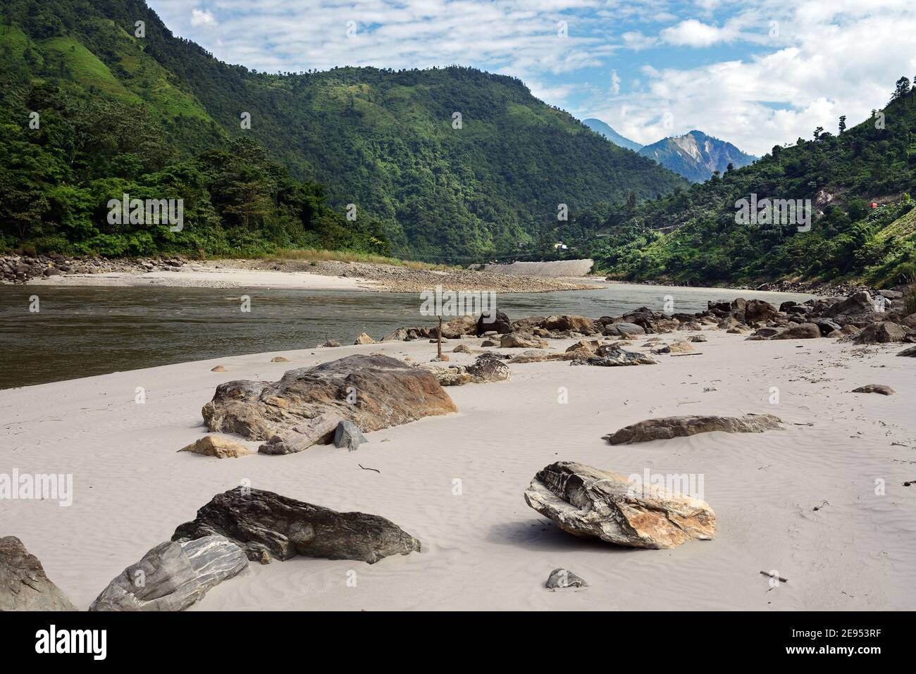 The Trishuli River is a major tributary of the Narayani River in central Nepal but originates in Tibet. Here it is adjacent to the Prithvi Highway. Stock Photo