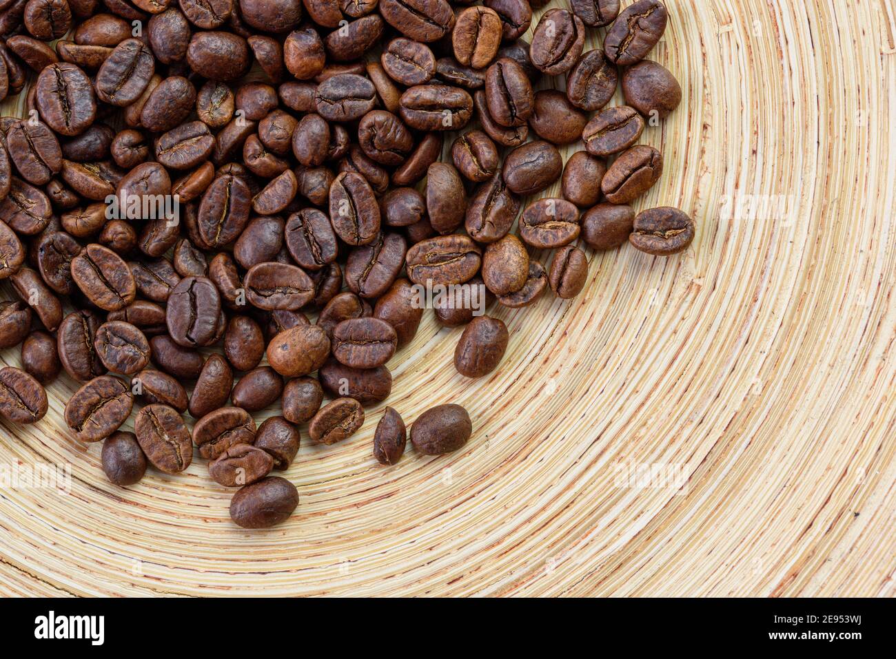 Decaffeinated coffee beans in a bowl, sunny, warm colors, close-up, top view, flat lay Stock Photo