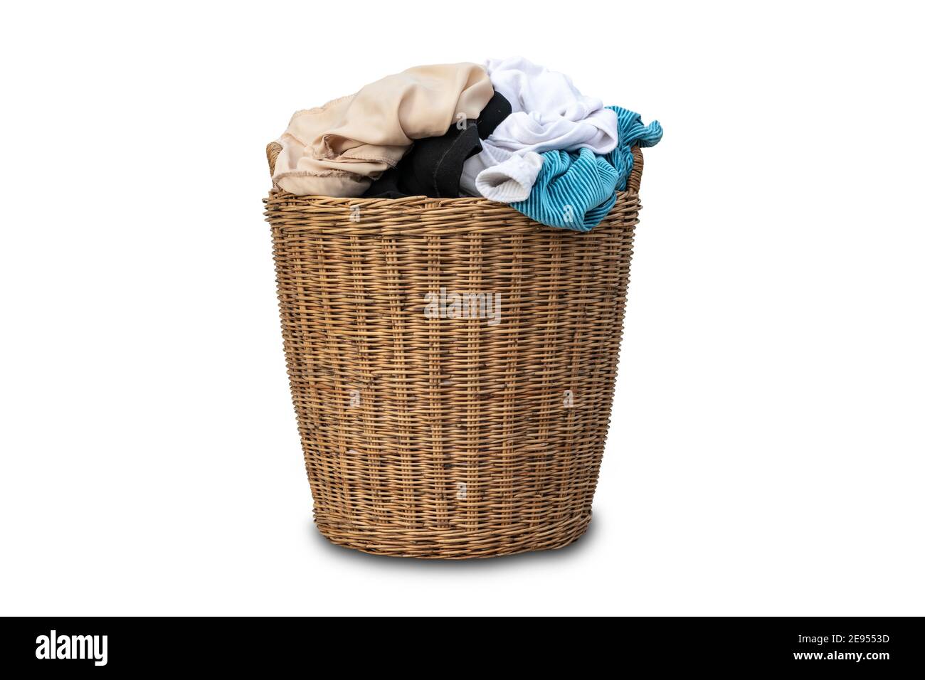 Clothes in a laundry wooden basket isolated on white background. Overflowing laundry basket. clipping path Stock Photo