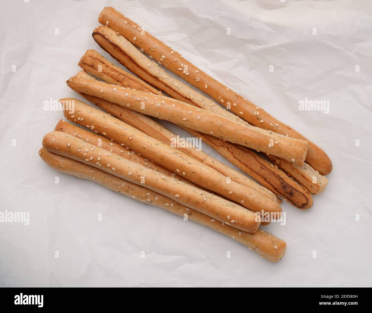 Top view of italian grissini Alamy Stock breadsticks baking on paper - Photo