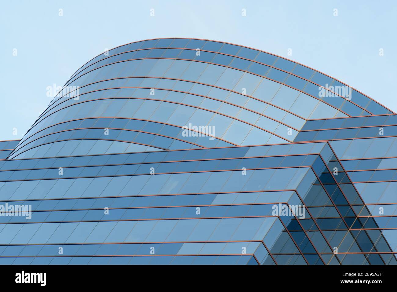 section of a modern blue glass building with symmetric lines and reflections Stock Photo