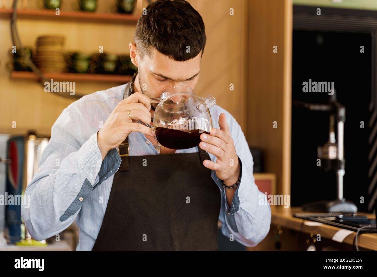 Young Beautiful Caucasian Barista Pouring Coffee With Syphon