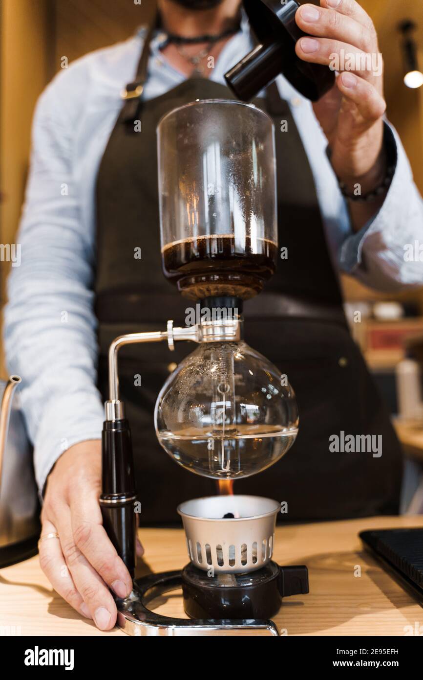 https://c8.alamy.com/comp/2E95EFH/coffee-brewing-by-syphon-device-close-up-syphon-is-heating-by-fire-brewing-photo-on-the-fire-alternative-method-of-coffee-making-vertical-photo-fo-2E95EFH.jpg