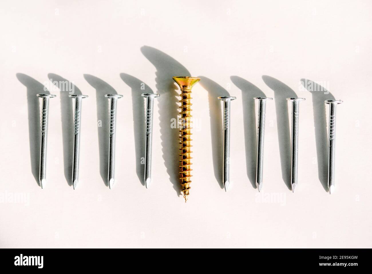 Business and business growth, individuality and independence.One screw opposite to them on a board is a lot of nails. A concept on a subject the Stock Photo